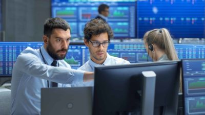 Two brokers analysing stocks.